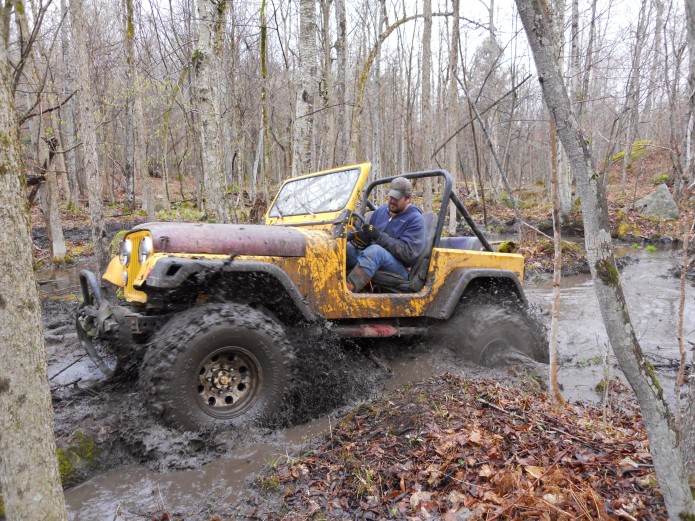 Joe Chase in Yellow Jeep CJ 7 with boggers in mud